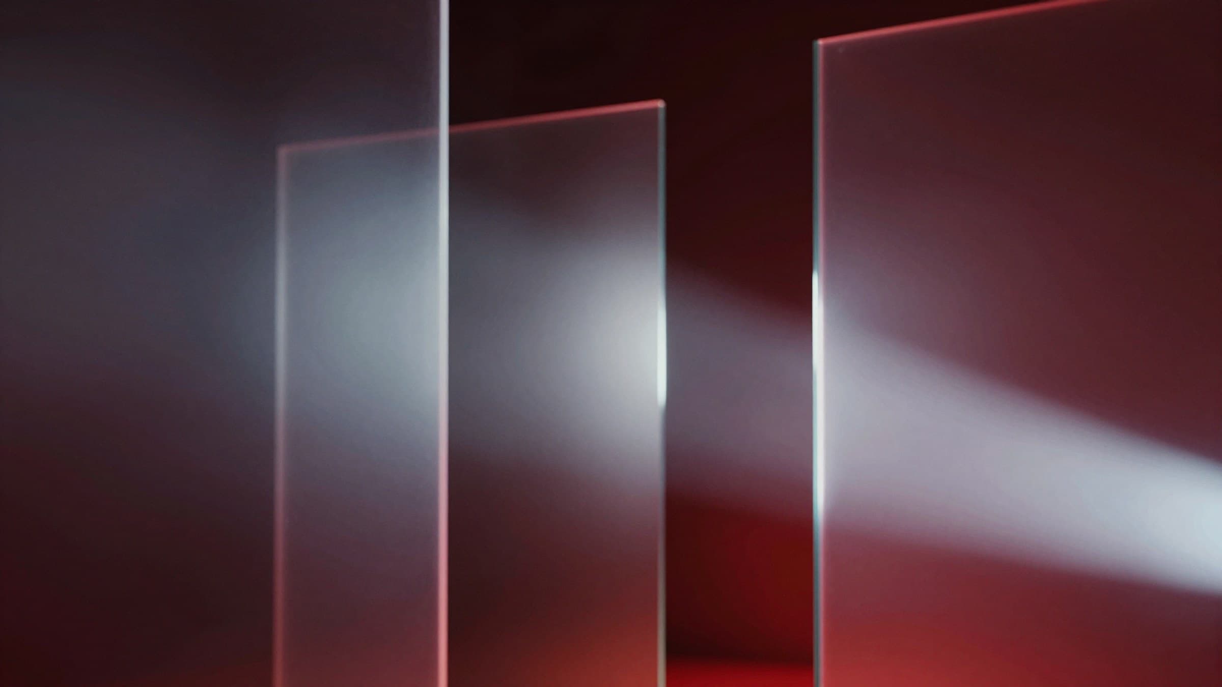 Abstract cinematic render of light rays refracting through glass panels, dark studio background