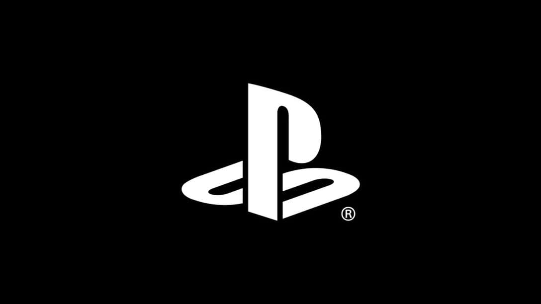 A PlayStation console sits beside a stack of physical game discs, illustrating Sony's shift toward all-digital software distribution.